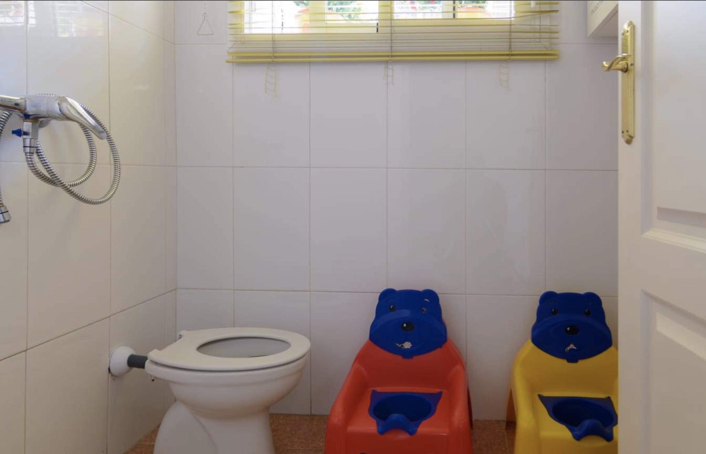 Baño infantil adaptado con sillas de colores